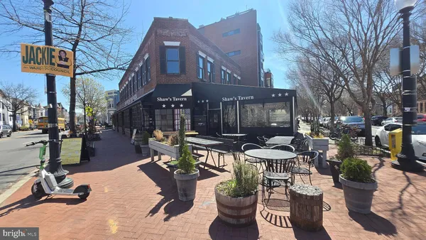 a view of a patio with dining table and chairs and potted plants