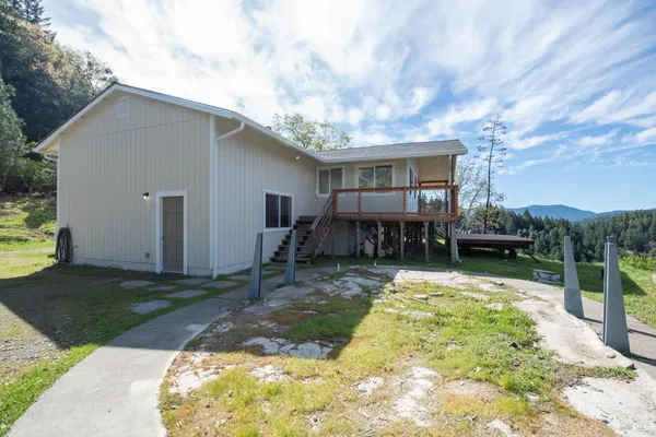 a backyard of a house with yard and barbeque oven