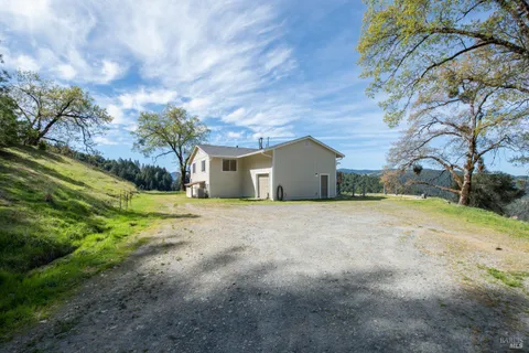 a view of a house with a yard and garage