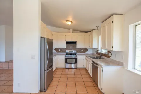a kitchen with stainless steel appliances a stove sink and cabinets