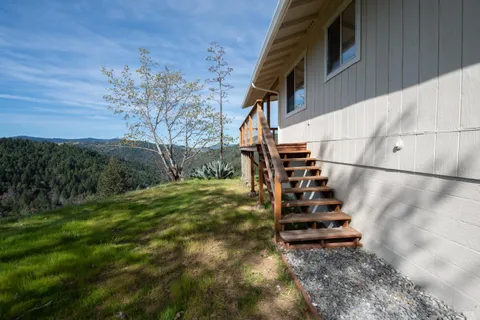 a view of a yard with wooden fence