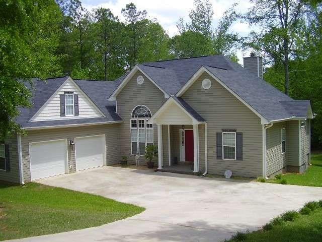 925 Blue Store Road Forsyth, GA 31029 - Photo 1 of 1 a house with a yard