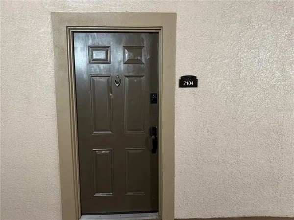 a bathroom with a glass door shower door and mirror