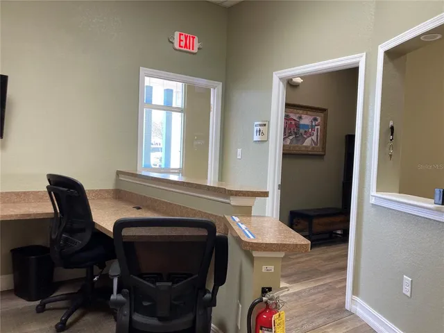 a kitchen with a chair a sink and a stove