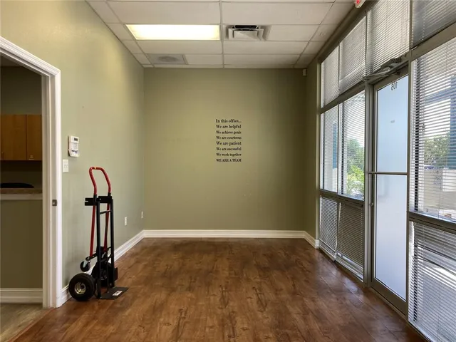 a view of a room with wooden floor and windows