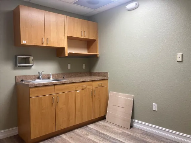 a room with cabinets appliances and a window
