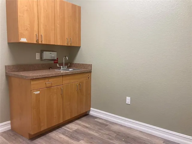 a room with a sink cabinets and utility