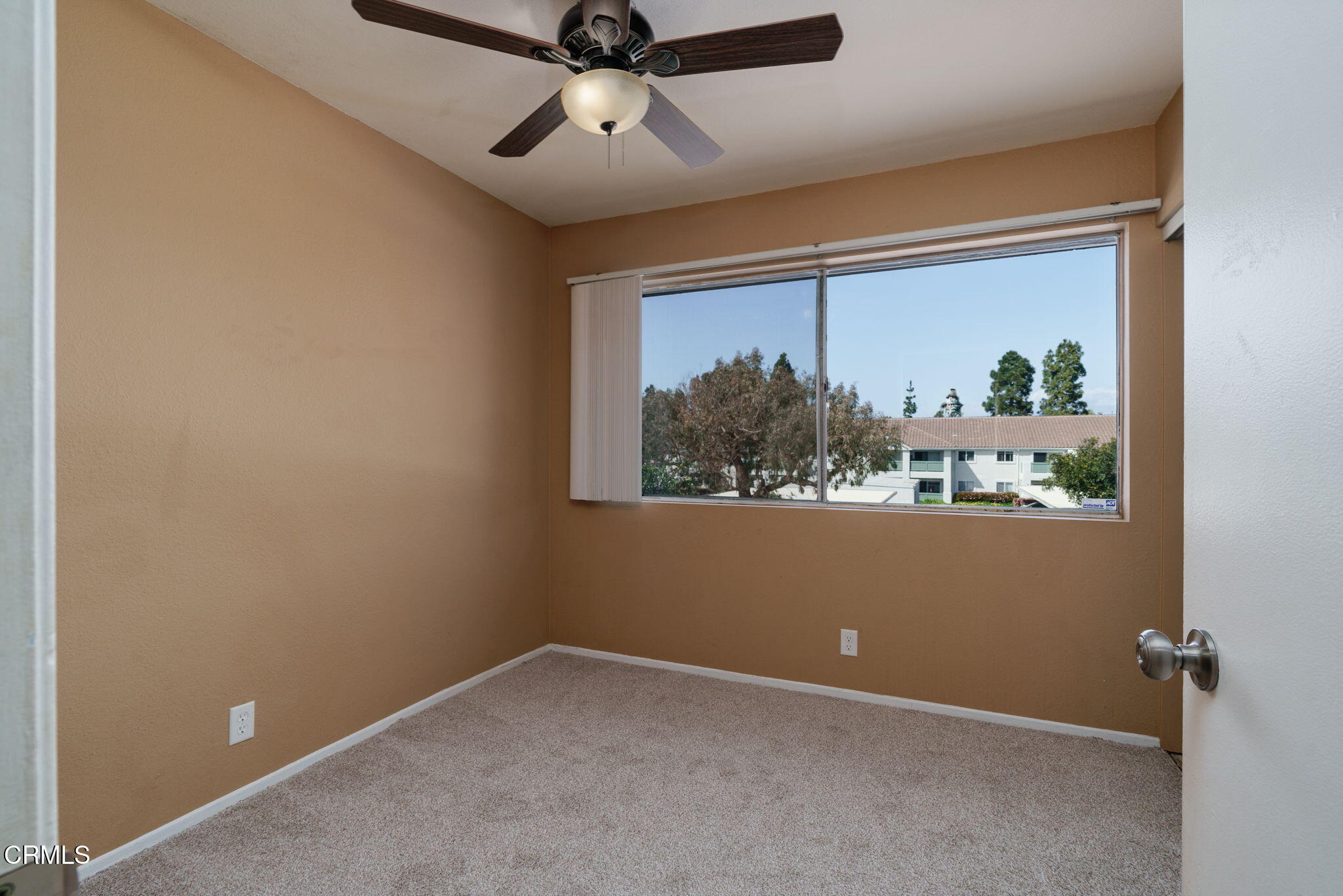 4526 Saviers Road Oxnard, CA 93033 - Photo 16 of 20 an empty room with a window and a ceiling fan