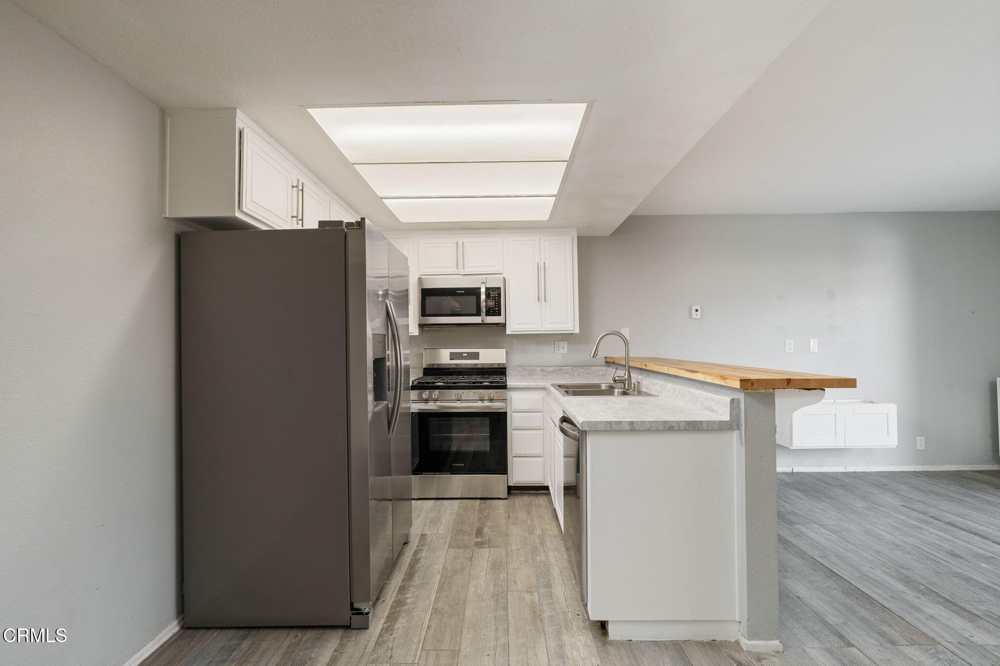 4526 Saviers Road Oxnard, CA 93033 - Photo 2 of 20 a kitchen with stainless steel appliances a stove refrigerator and a microwave