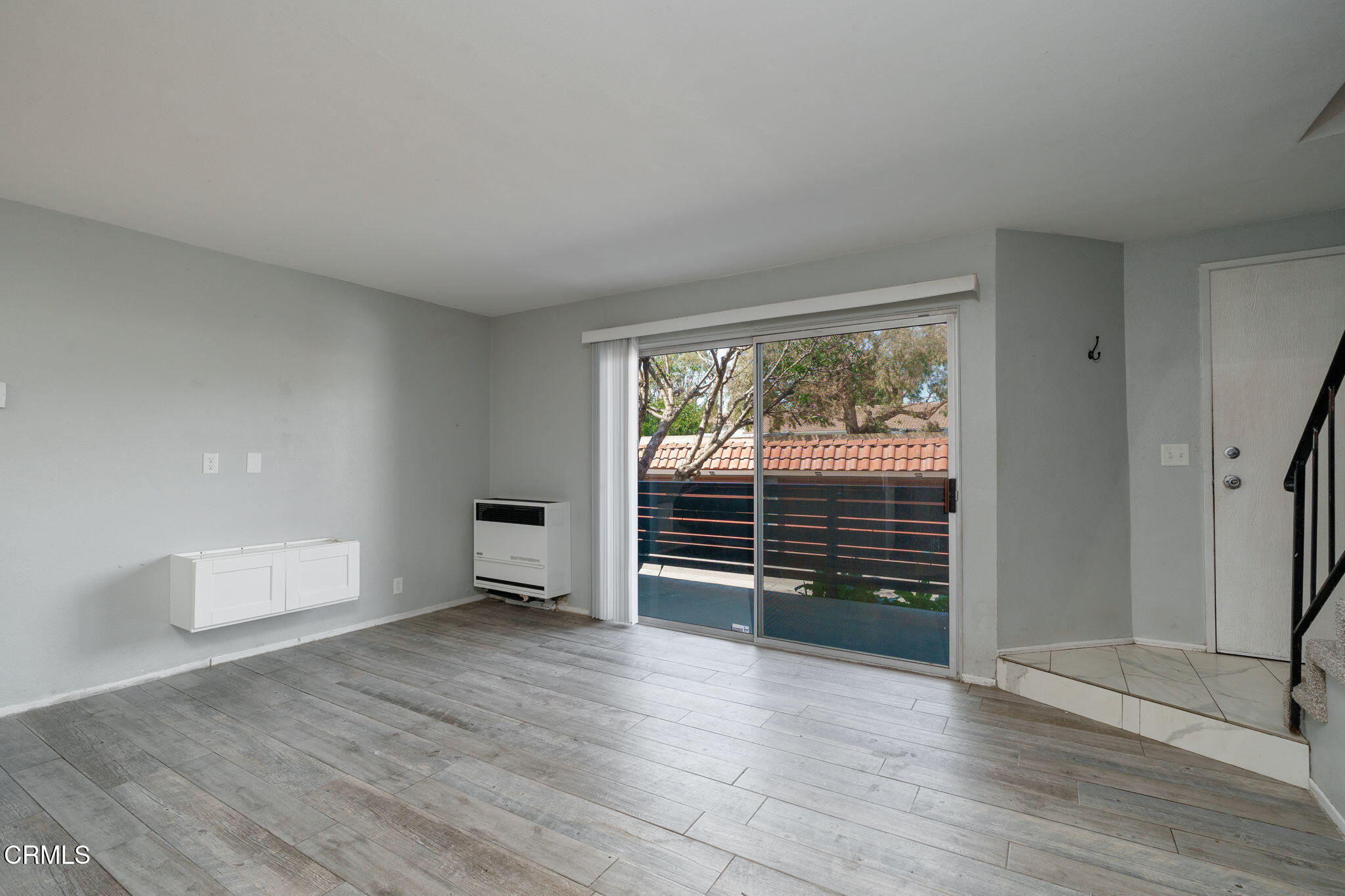 4526 Saviers Road Oxnard, CA 93033 - Photo 3 of 20 a view of an empty room with a window and wooden floor