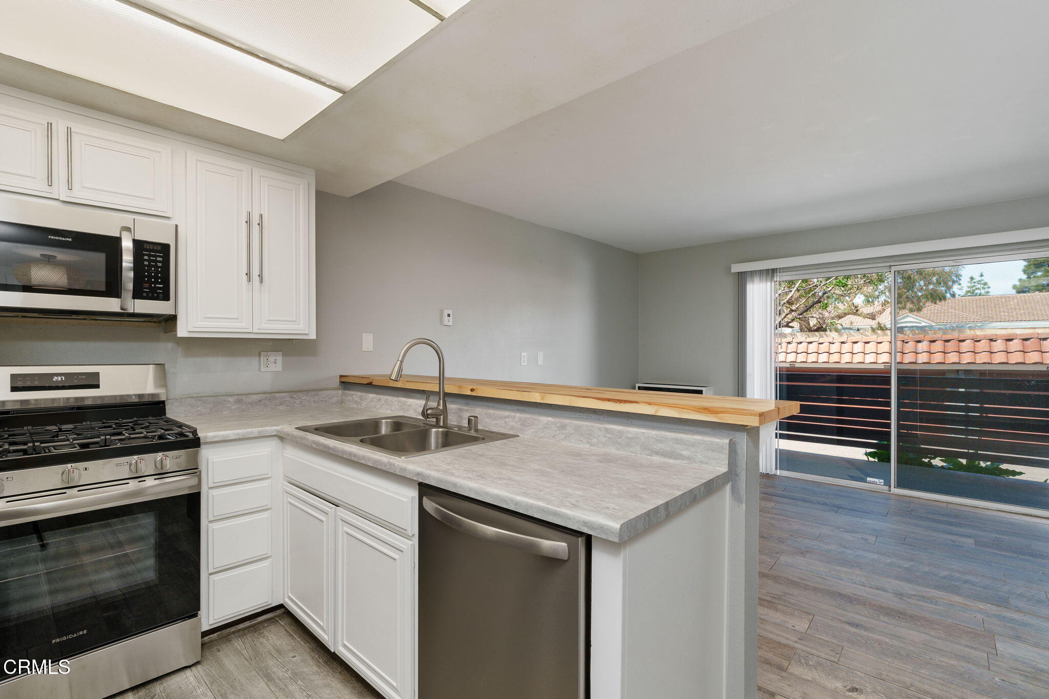 4526 Saviers Road Oxnard, CA 93033 - Photo 9 of 20 a kitchen with a stove a sink and a microwave