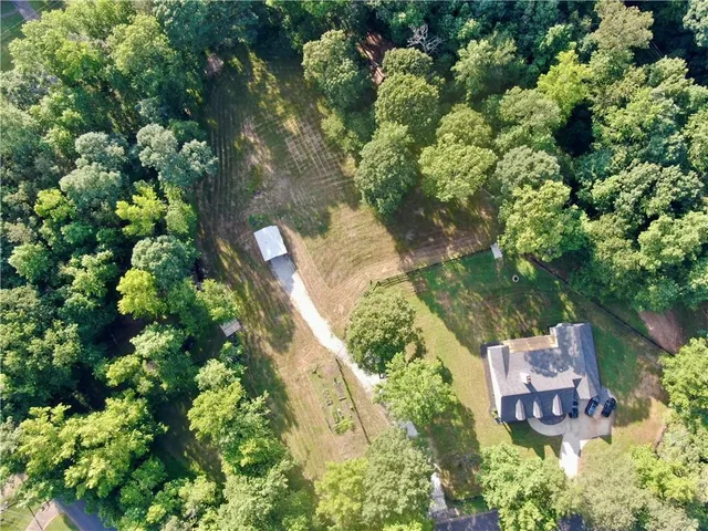 an aerial view of a house with a yard and garden