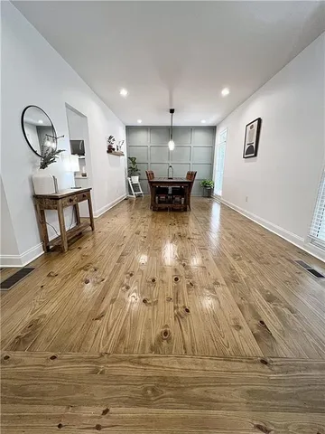 a room with lots of wooden furniture and a view of living room