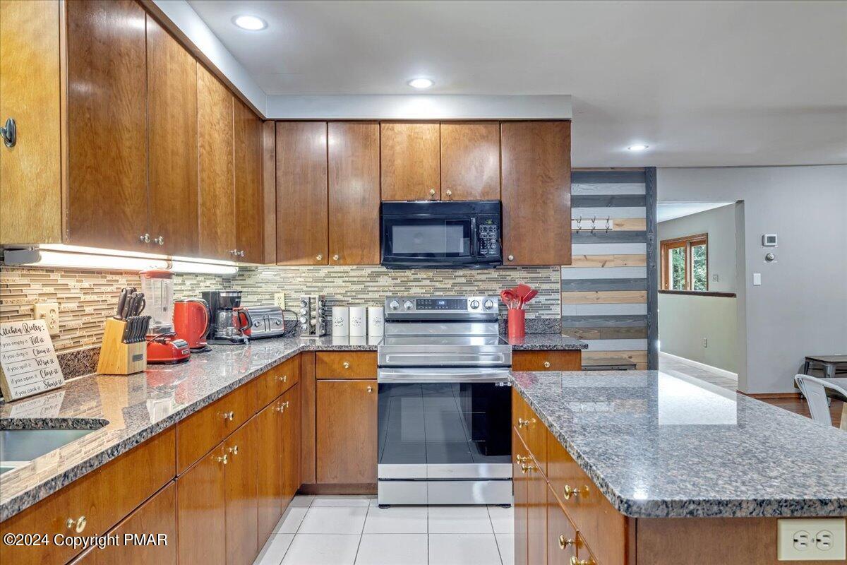 401 Minsi Trail West Long Pond, PA 18334 - Photo 11 of 34 a kitchen with stainless steel appliances granite countertop wooden cabinets a sink and dishwasher