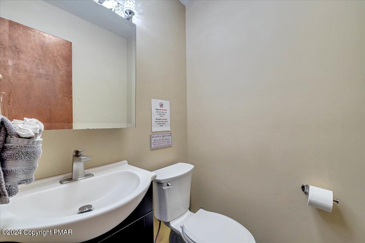 401 Minsi Trail West Long Pond, PA 18334 - Photo 18 of 34 a bathroom with a sink a toilet and mirror