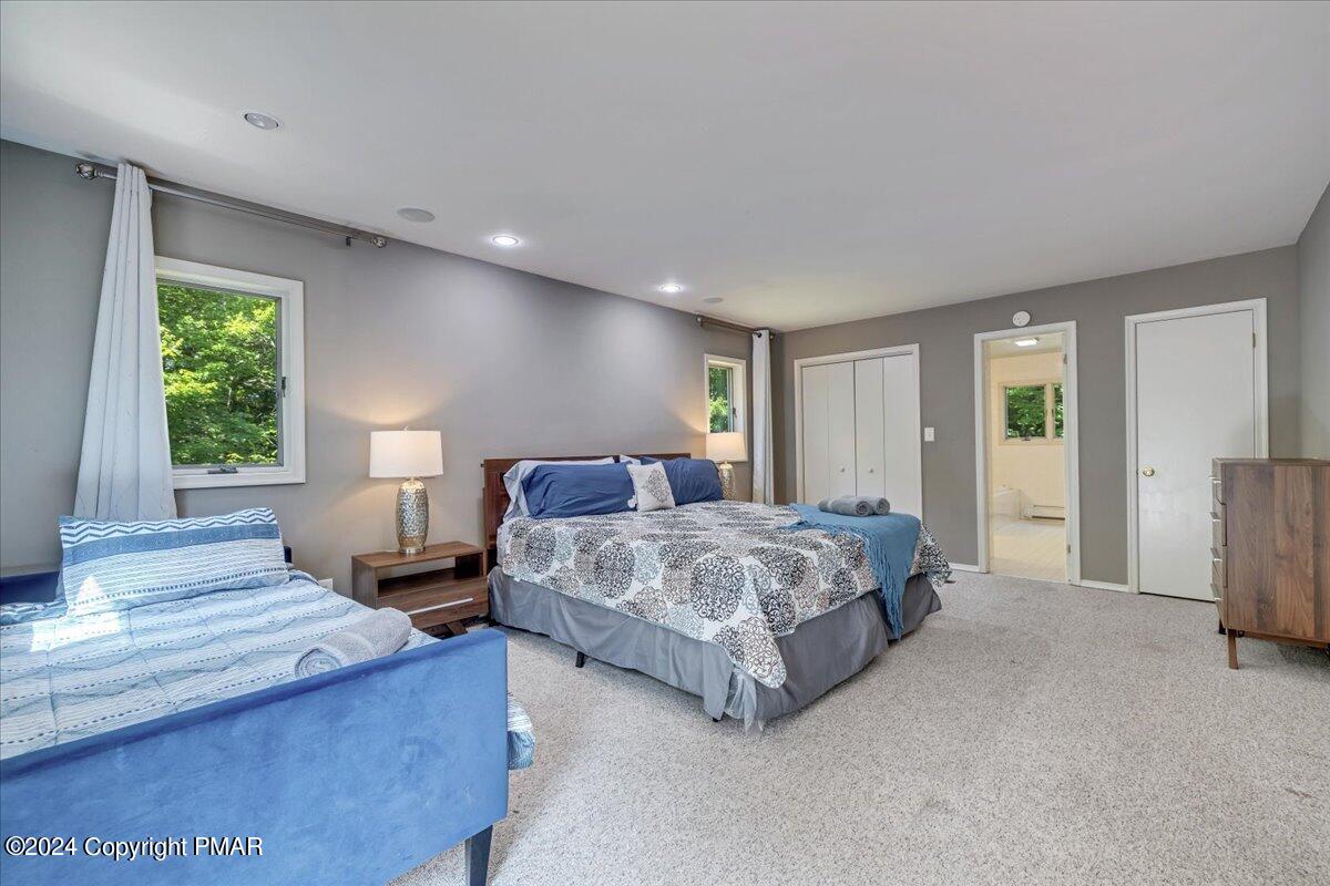 401 Minsi Trail West Long Pond, PA 18334 - Photo 19 of 34 a spacious bedroom with a bed and a large window