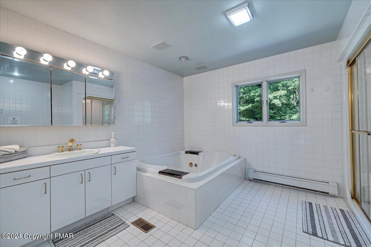 401 Minsi Trail West Long Pond, PA 18334 - Photo 24 of 34 a bathroom with a sink and mirror with toilet