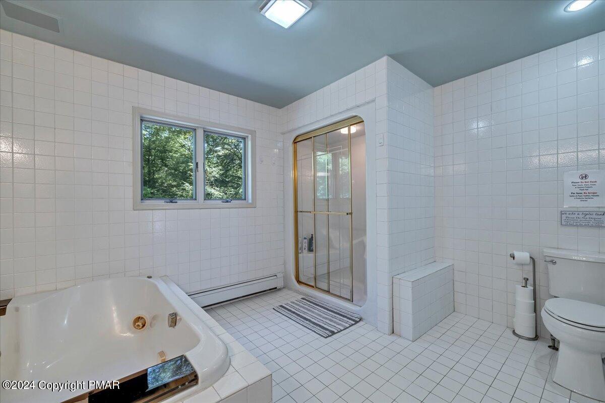 401 Minsi Trail West Long Pond, PA 18334 - Photo 25 of 34 a bathroom with a tub a toilet and a shower