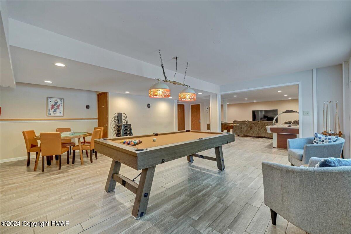 401 Minsi Trail West Long Pond, PA 18334 - Photo 30 of 34 a living room with furniture a dining table and a chandelier