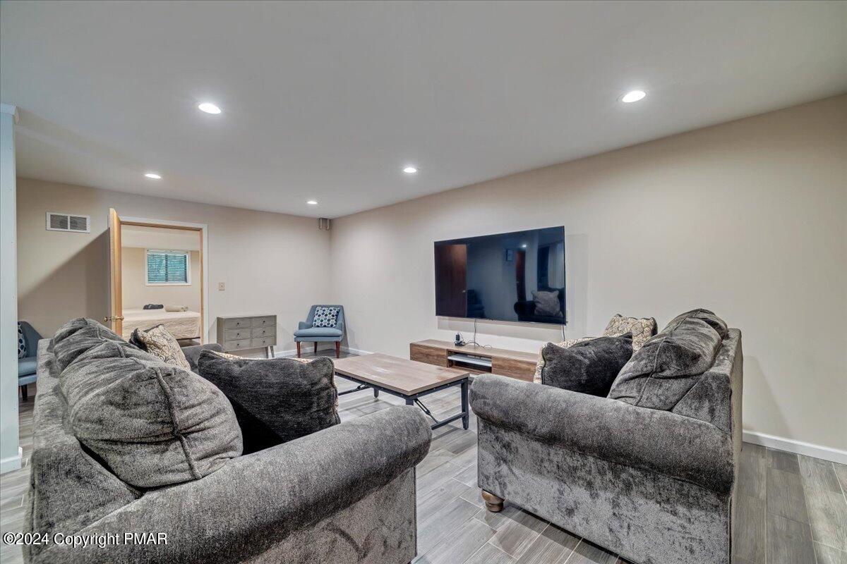 401 Minsi Trail West Long Pond, PA 18334 - Photo 31 of 34 a living room with furniture and a flat screen tv