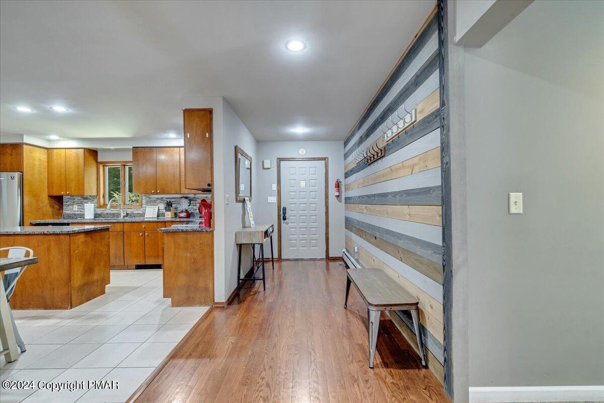 401 Minsi Trail West Long Pond, PA 18334 - Photo 7 of 34 a kitchen with stainless steel appliances granite countertop a refrigerator a oven a sink with island and chairs