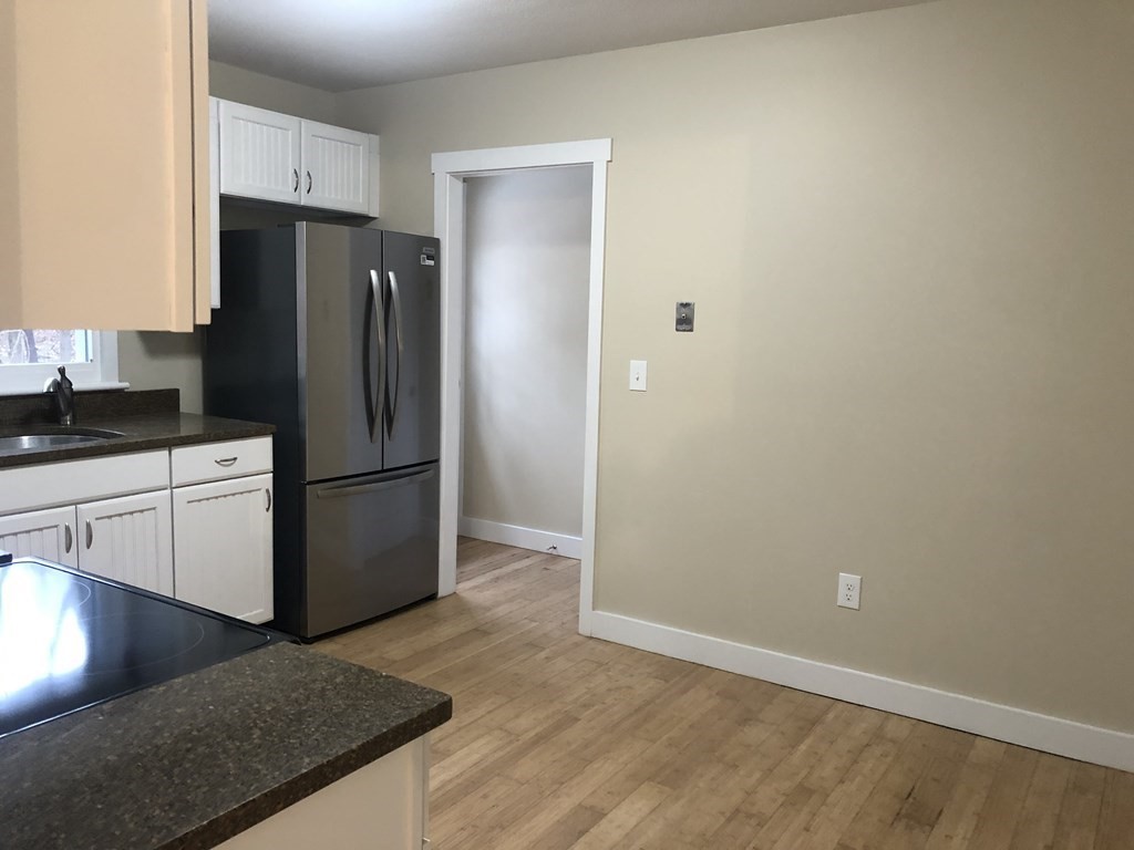 39 Stone School Road Sutton, MA 01590 - Photo 4 of 14 a kitchen with a refrigerator and a sink