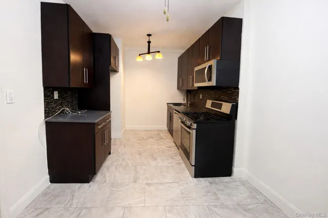 a kitchen with granite countertop a stove and a refrigerator