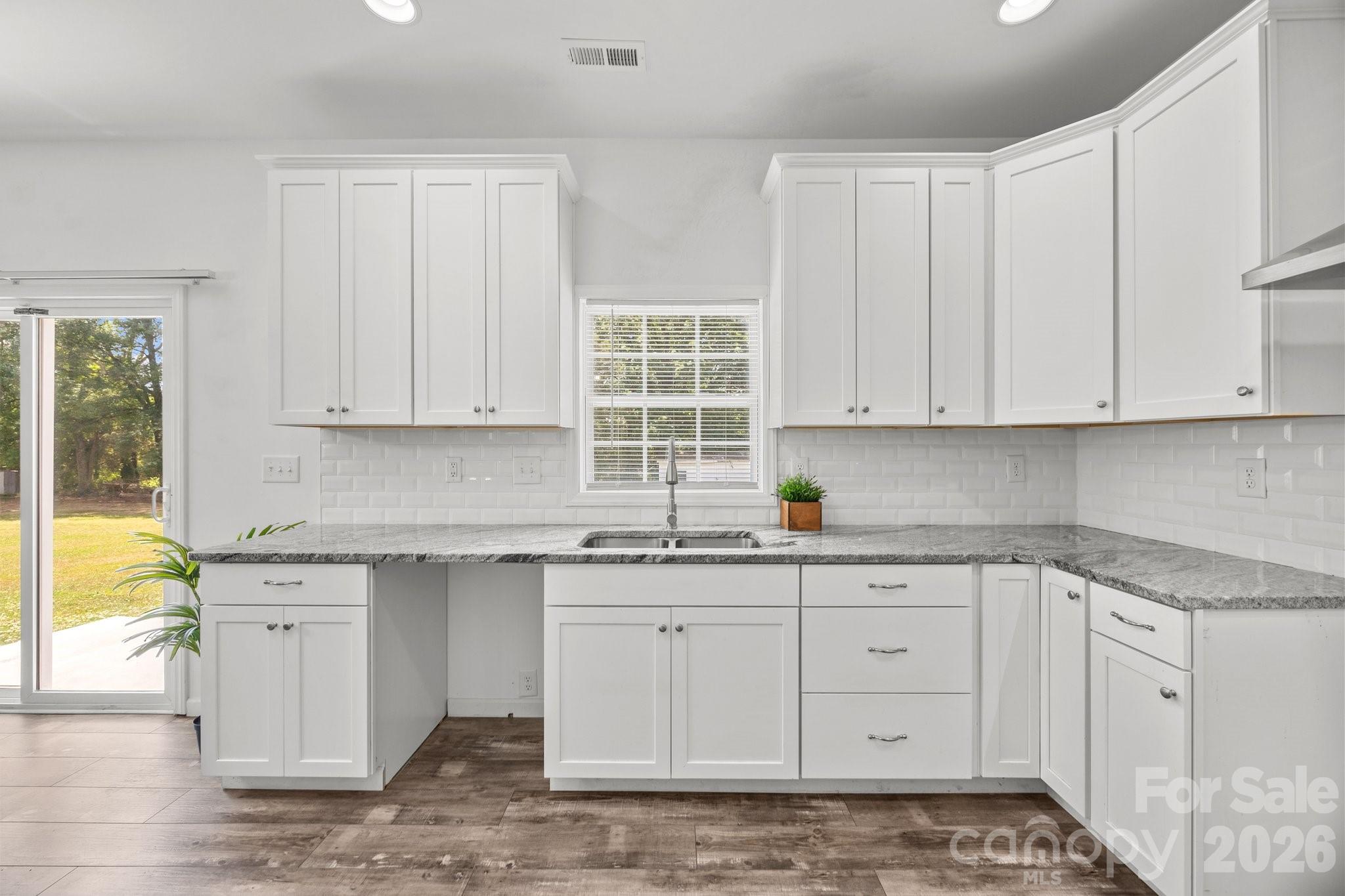 14532 East Rocky River Road Davidson, NC 28036 - Photo 20 of 32 a kitchen with stainless steel appliances granite countertop a sink and cabinets
