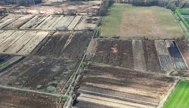 an aerial view of a house with a yard basket ball court and outdoor seating