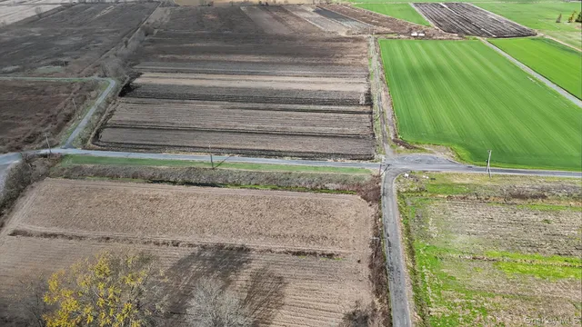 an aerial view of a house with a yard and sitting area