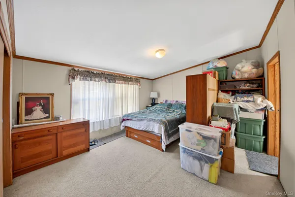 a bedroom with furniture and a flat tv screen