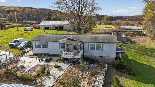 an aerial view of a house with a yard basket ball court and outdoor seating