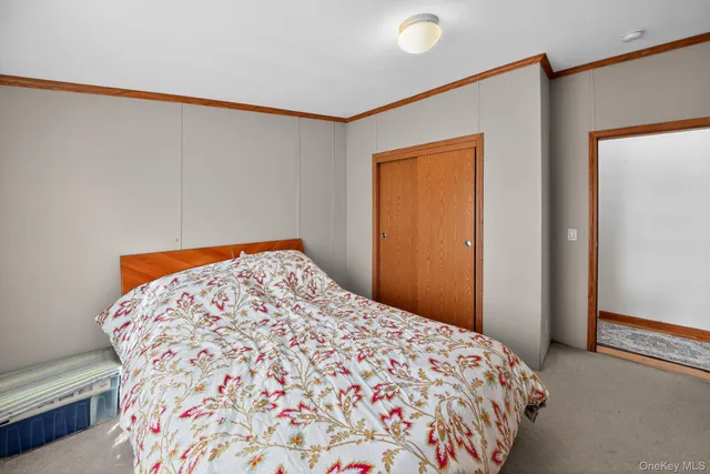 a bedroom with furniture and a flat tv screen