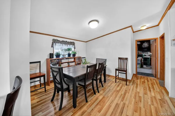 a view of a dining room with furniture and wooden floor