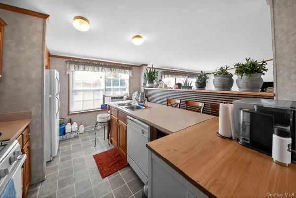 a kitchen with a sink appliances and cabinets