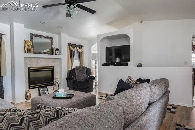 a living room with furniture and a mirror