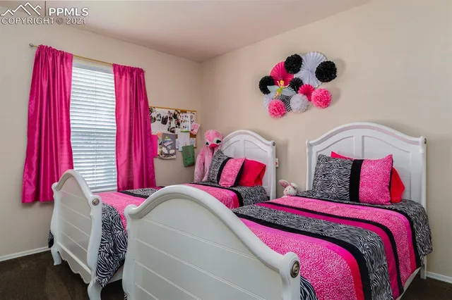 a view of a livingroom with workspace and a window