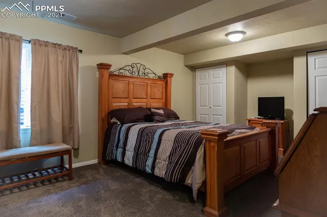 a bedroom with a bed and a dresser