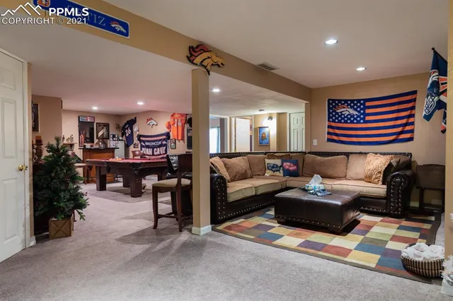 a living room with fireplace furniture and a flat screen tv