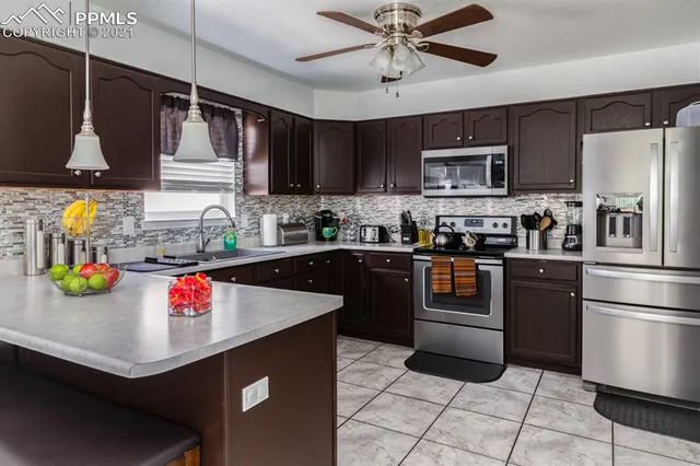 a kitchen with stainless steel appliances granite countertop a sink refrigerator and microwave