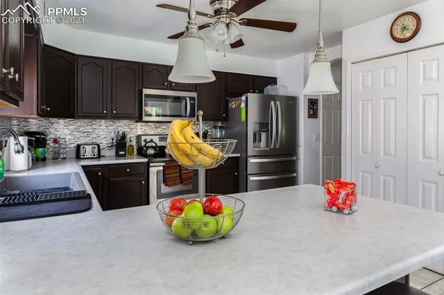 a kitchen with stainless steel appliances a stove a refrigerator and cabinets