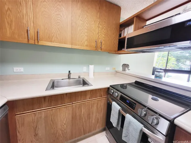 a kitchen with a sink stove and cabinets