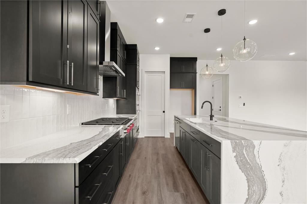 322 Treble Way Alpharetta, GA 30009 - Photo 12 of 67 a kitchen with stainless steel appliances granite countertop a sink a stove and a refrigerator