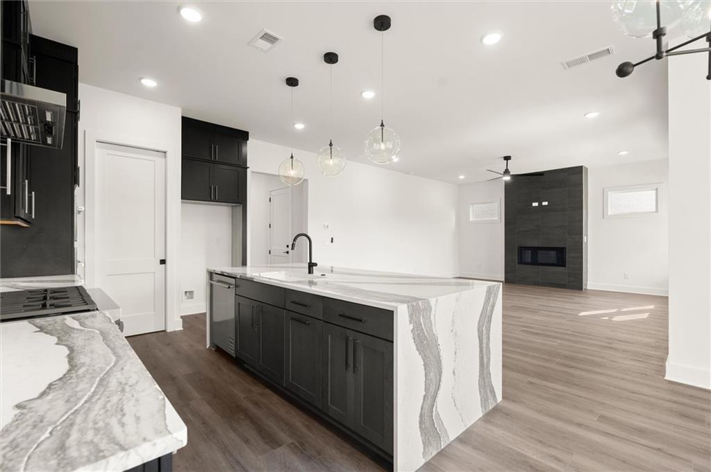 322 Treble Way Alpharetta, GA 30009 - Photo 13 of 67 a large white kitchen with a sink and stainless steel appliances