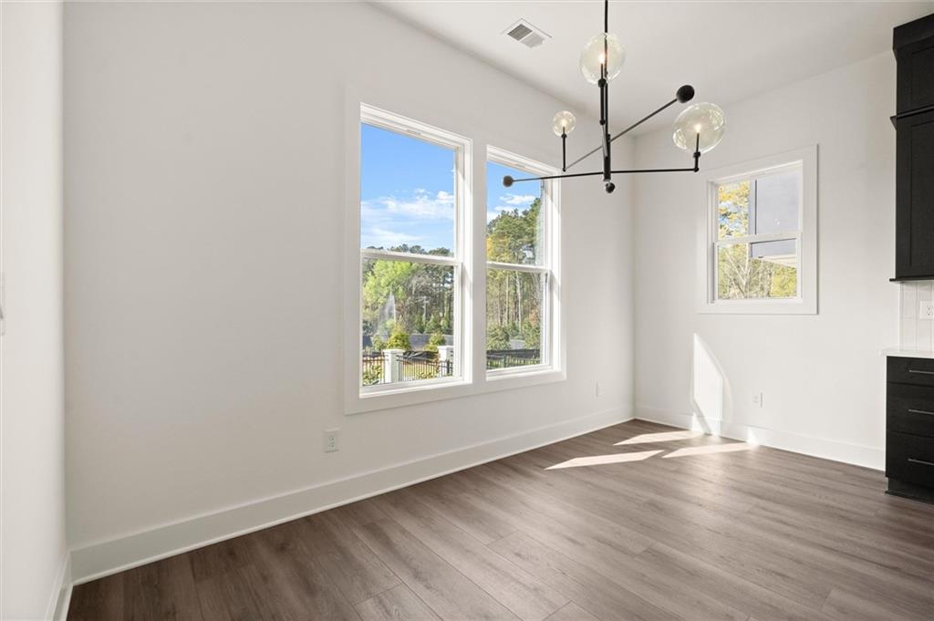 322 Treble Way Alpharetta, GA 30009 - Photo 15 of 67 a view of an empty room with wooden floor and a window