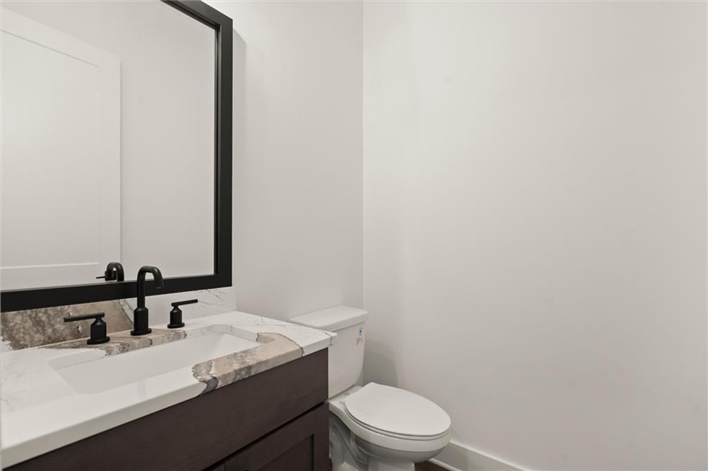 322 Treble Way Alpharetta, GA 30009 - Photo 19 of 67 a bathroom with a granite countertop sink toilet and mirror