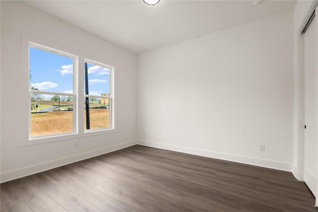 322 Treble Way Alpharetta, GA 30009 - Photo 25 of 67 a view of an empty room with wooden floor and a window