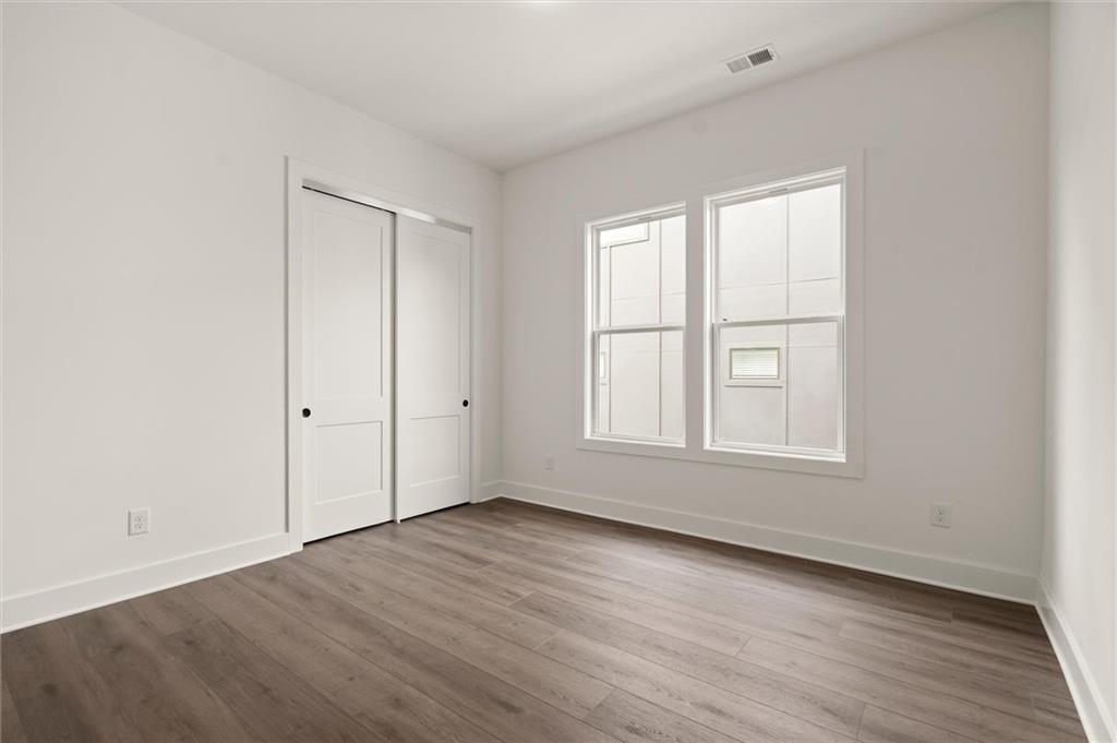 322 Treble Way Alpharetta, GA 30009 - Photo 27 of 67 an empty room with wooden floor and windows