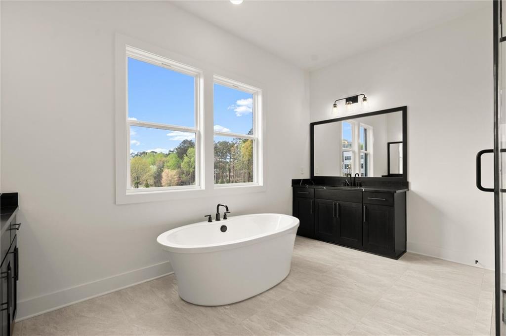 322 Treble Way Alpharetta, GA 30009 - Photo 32 of 67 a white bath tub sitting in a bathroom