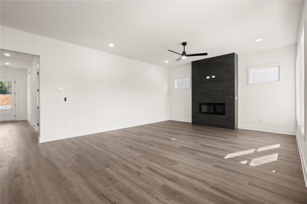 322 Treble Way Alpharetta, GA 30009 - Photo 5 of 67 a view of empty room with wooden floor and fireplace